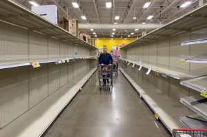 Grocery store aisle with empty shelves