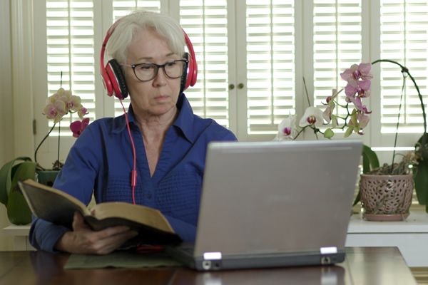 A lay minister taking an online course.